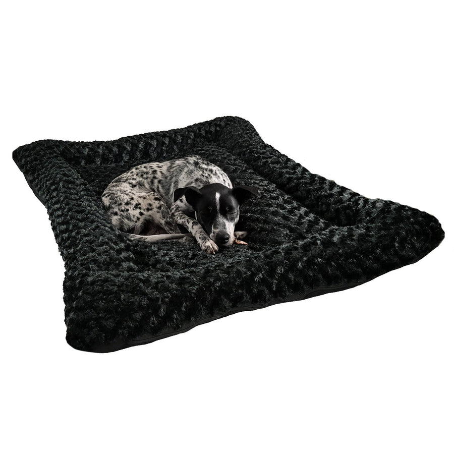 Spotted dog resting on a black Cloud Furvana rectangle bolster dog bed