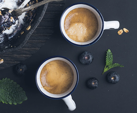 Two cups of coffee pictured as a serving suggestion for Blueberry Cobbler coffee