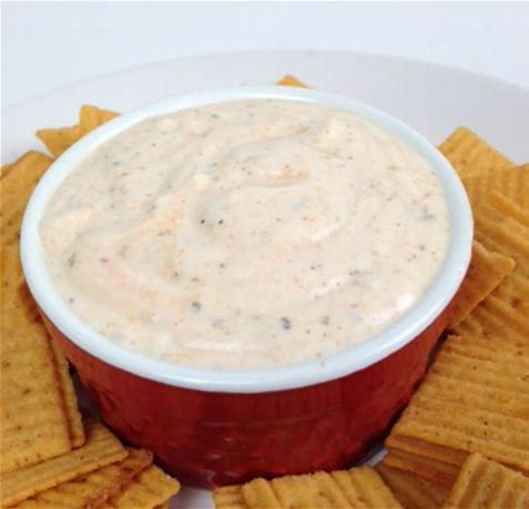 Creamy Buffalo Ranch dip in a red bowl with chips
