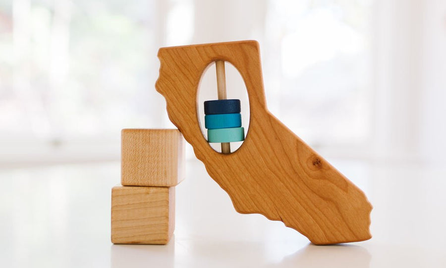 California state-shaped cherry wood baby rattle with colored center disks