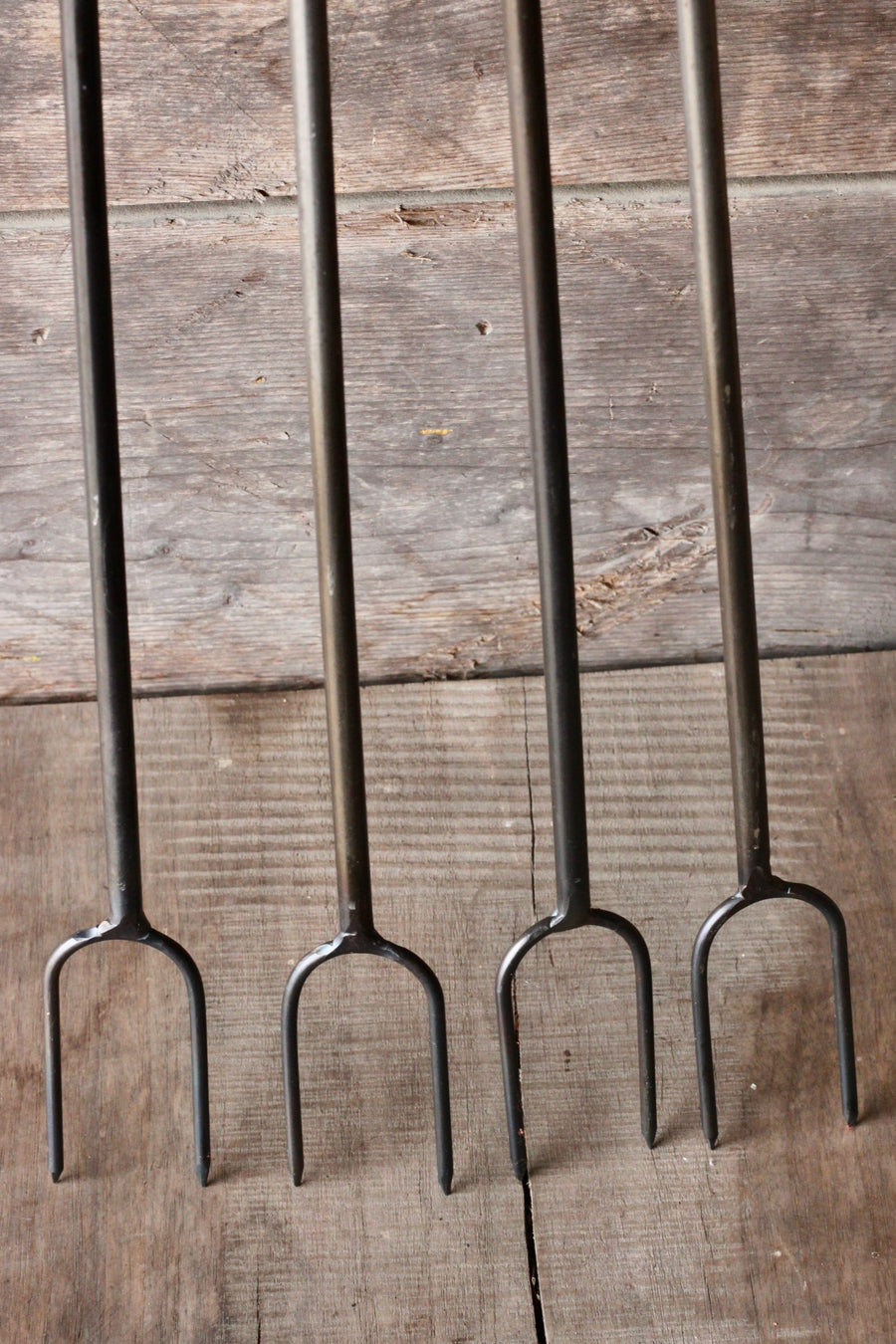Four campfire roasters with looped handles
