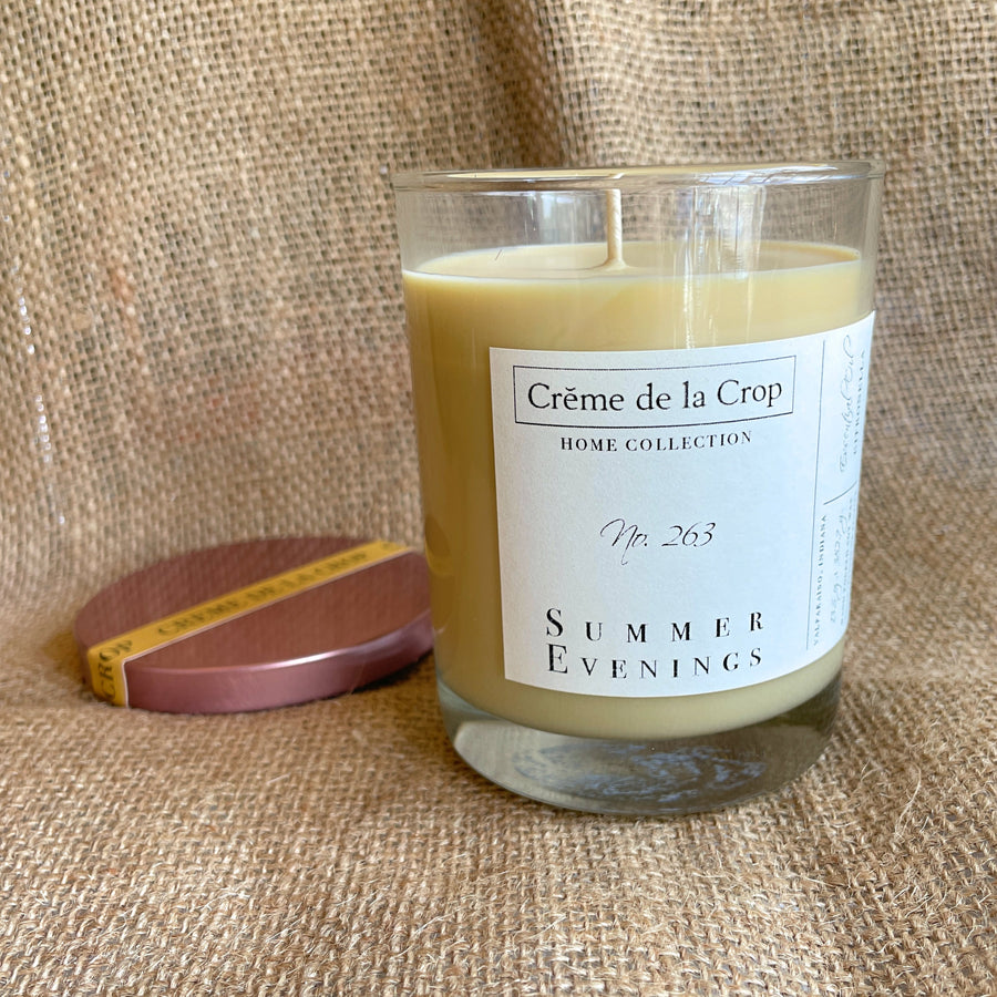 Summer Evenings citronella candle with its optional lid beside the glass