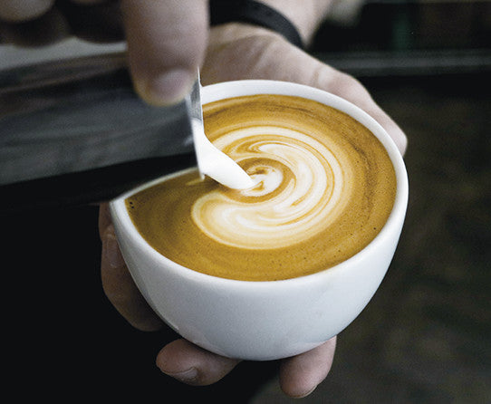 Serving suggestion: steamed milk poured into a cup of coffee