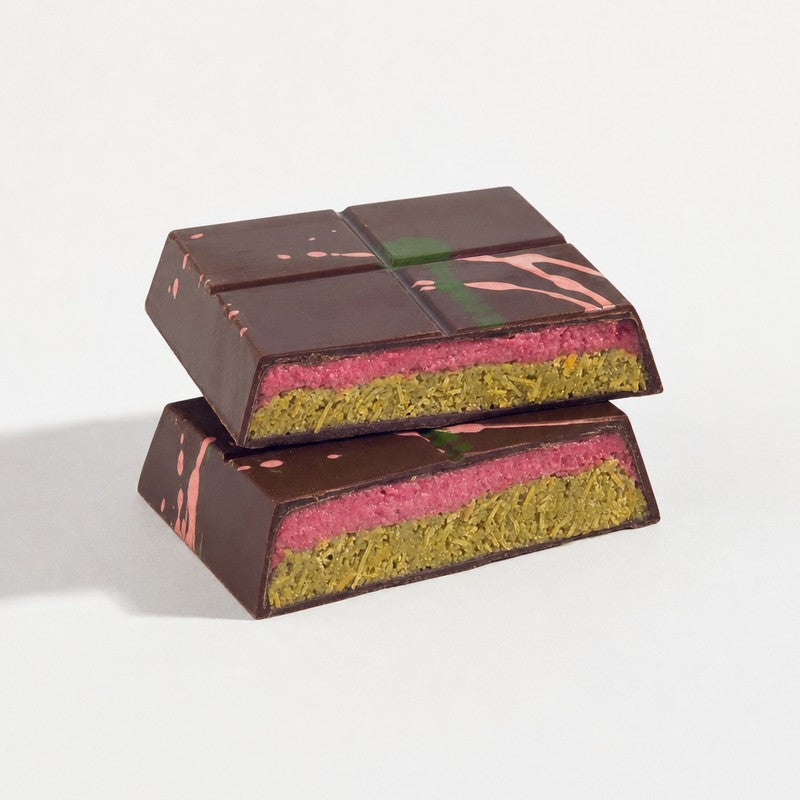 Cut raspberry ganache Dubai bar showing raspberry and pistachio layers