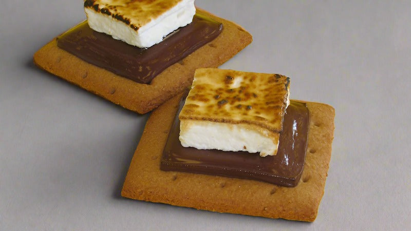 Toasted marshmallow smores stacked with dark chocolate and graham cracker bases