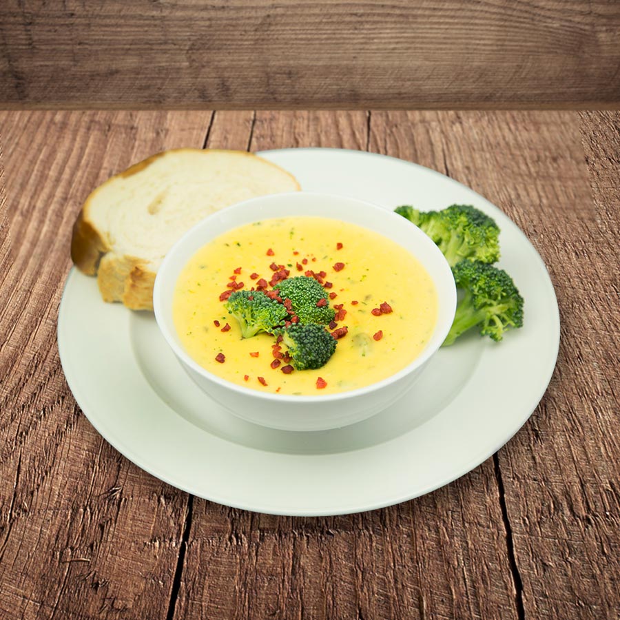Prepared cheddar broccoli soup with bread, serving suggestion