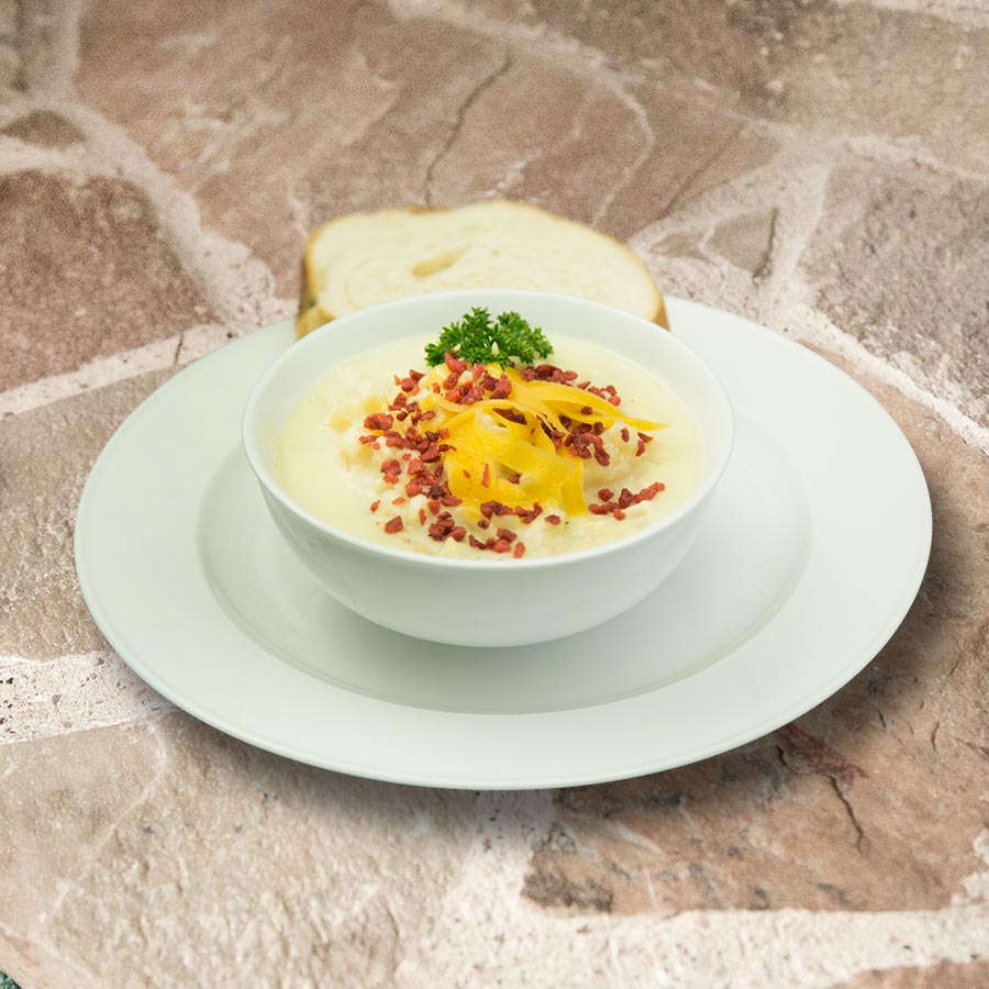 Prepared cheesy potato soup with bread, serving suggestion