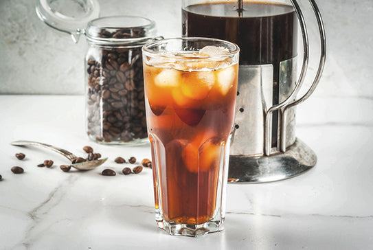 Serving suggestion: iced coffee in a glass beside a French press