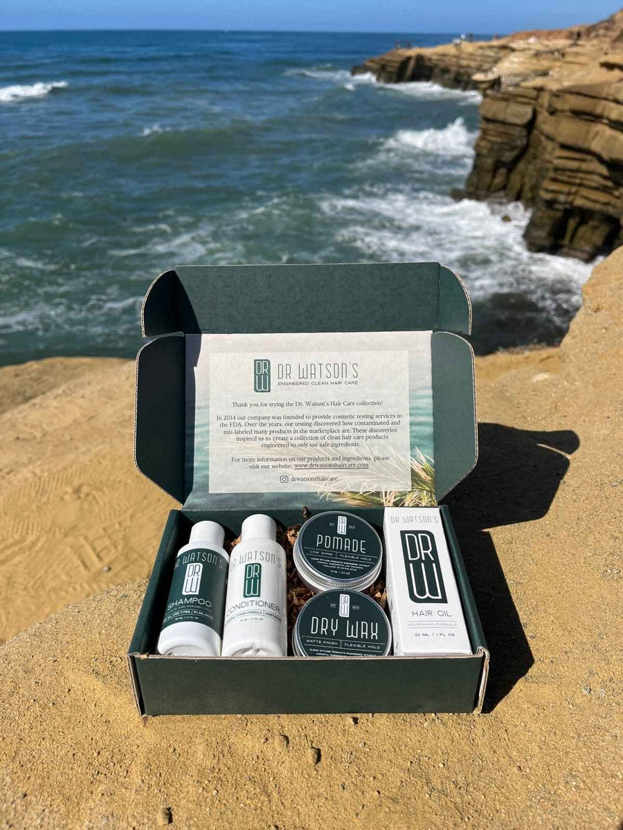 Open Dr. Watson's five-product Discovery Set beside ocean cliffs