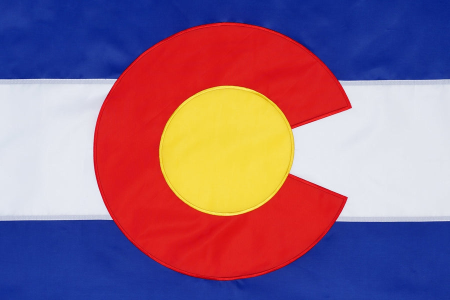 Colorado state flag close-up with red C and gold center