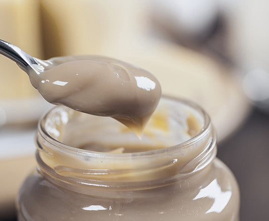 Sweet milk spread pictured as flavor inspiration for Dulce de Leche coffee