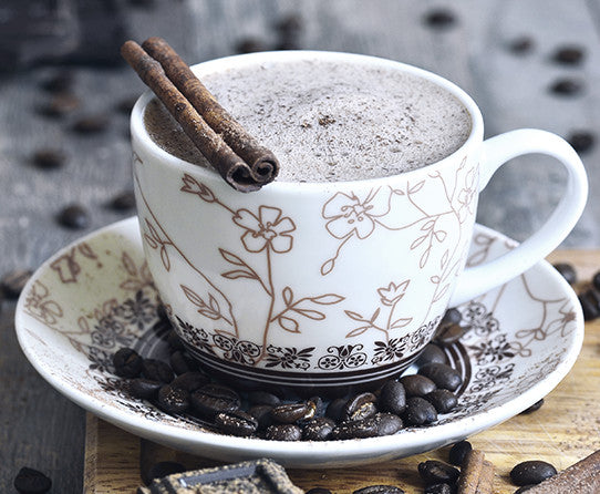 Serving suggestion: creamy coffee in a patterned cup with spices pictured beside it