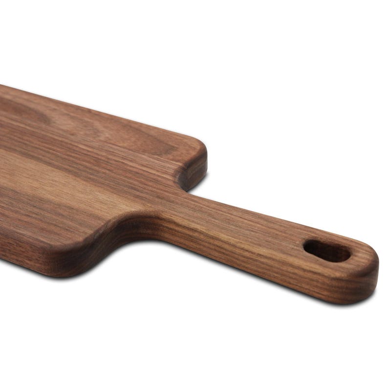 Close view of a walnut paddle's handle and hanging hole