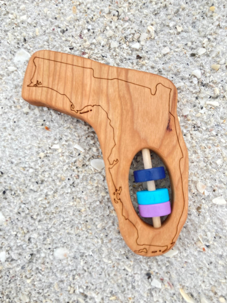 Florida state-shaped cherry wood baby rattle with colored center disks