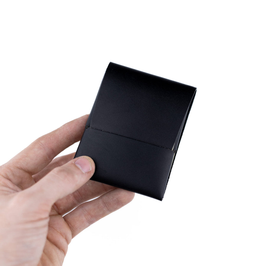 Black Franklin 2 leather wallet, held open to show the front flap