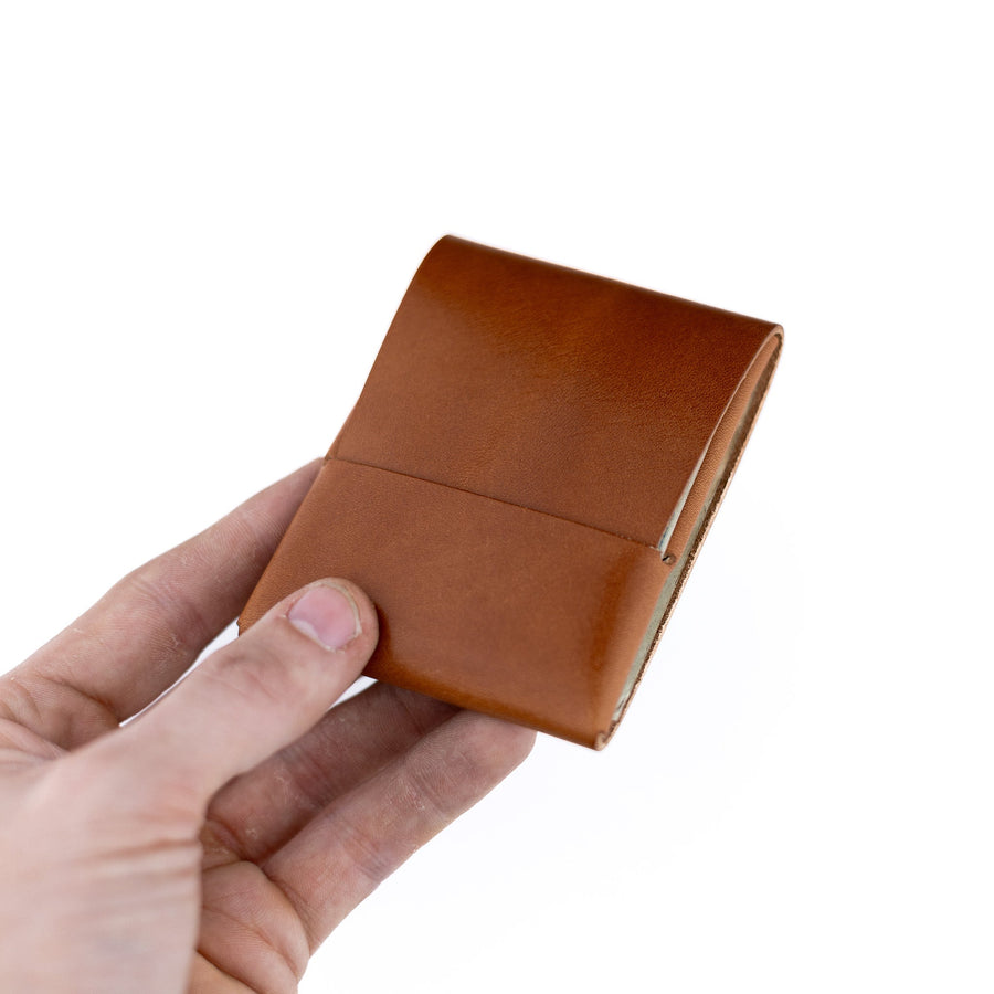 Brown Franklin 2 leather wallet, held open to show the front flap