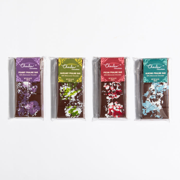 Four wrapped praline crunch bars in peanut, hazelnut, pecan, and almond flavors