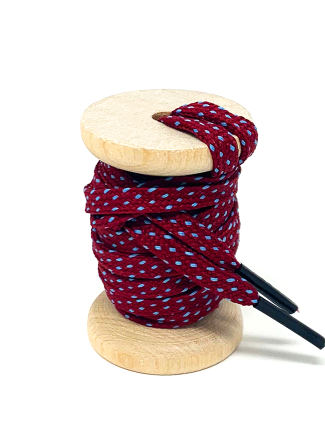 Garnet & Light Blue ticked flat shoelaces on a wooden spool