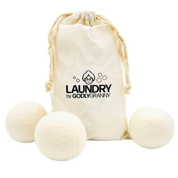 White wool dryer balls displayed with a drawstring storage bag