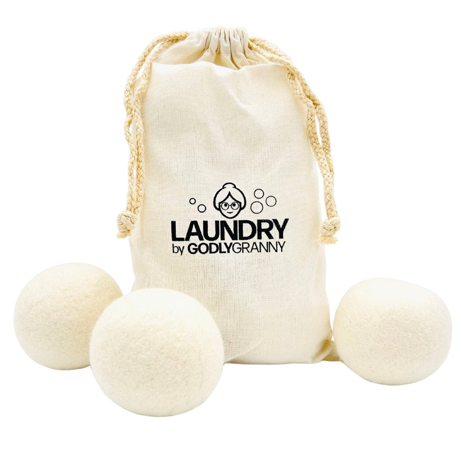 White wool dryer balls displayed with a drawstring storage bag