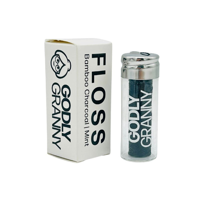 Mint bamboo charcoal dental floss in a glass jar with a labeled carton