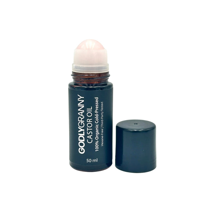 Amber castor oil bottle with rose quartz roller applicator and cap