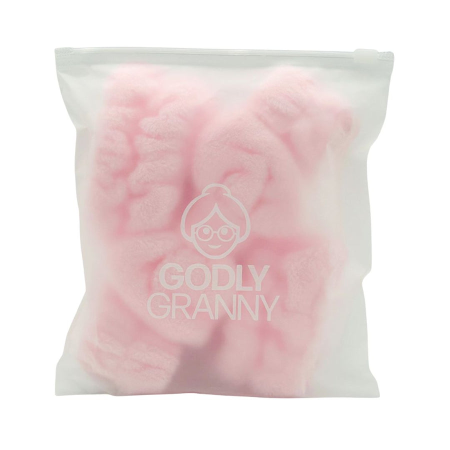 Pink headband and wristband set inside a logo storage bag