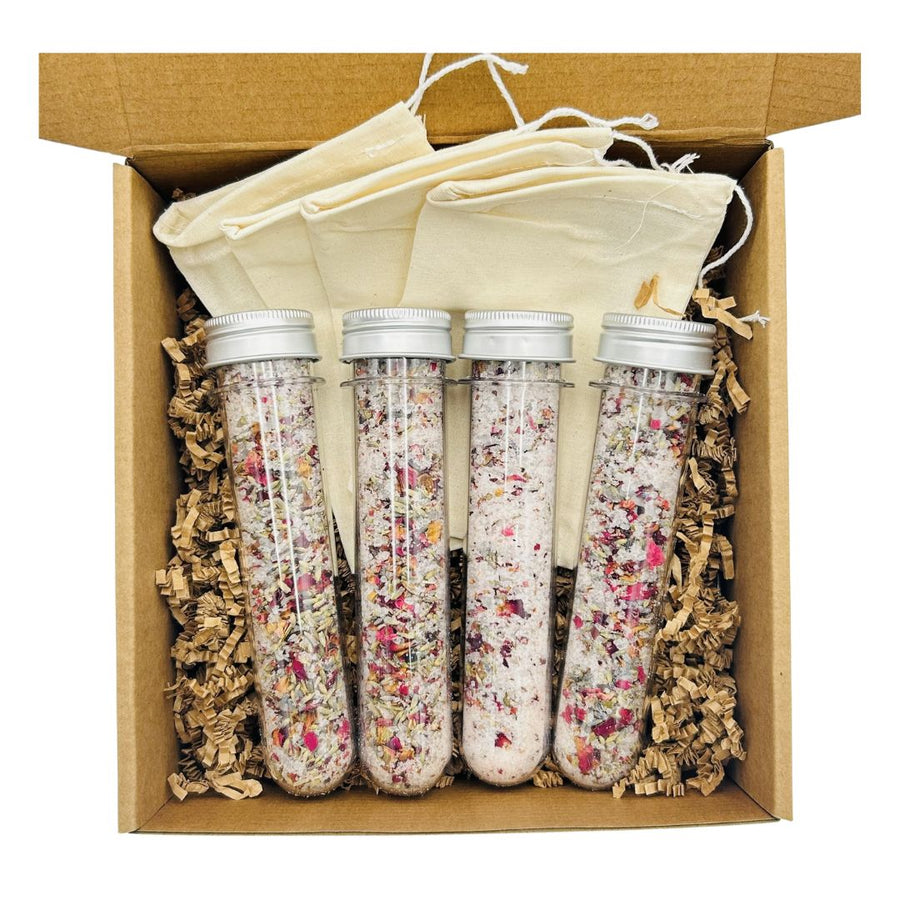 Four botanical bath-salt vials in a gift box with muslin bags