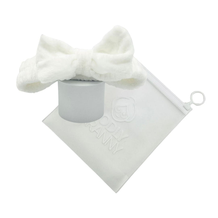 White plush bow headband arranged around a logo storage bag