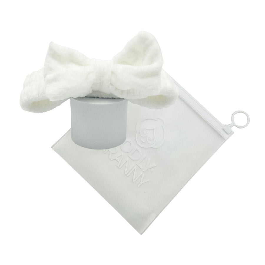 White plush bow headband arranged around a logo storage bag