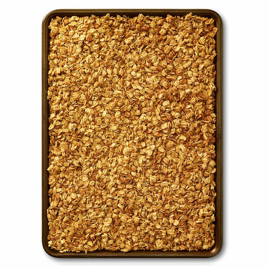 Gluten-Free Honey Oat Granola - granola spread across a baking tray