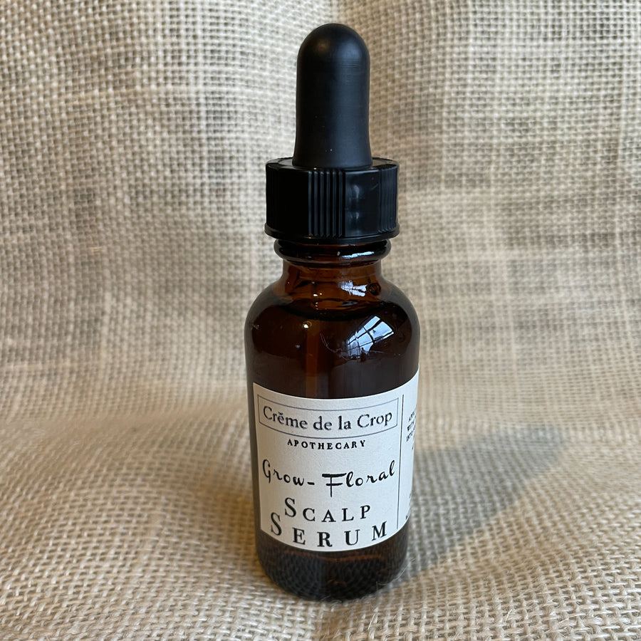Floral Grow scalp serum in an amber dropper bottle