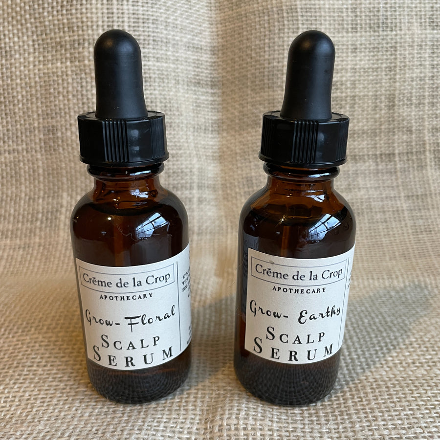 Floral and Earthy Grow scalp serum dropper bottles side by side