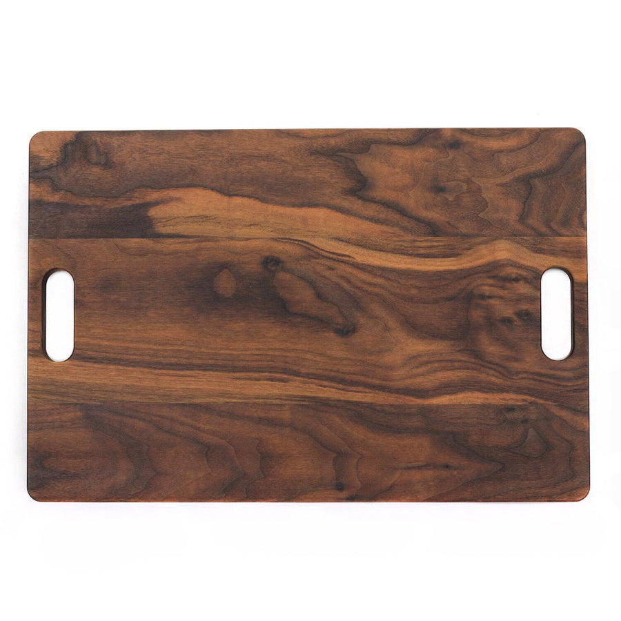 Front view of a walnut butcher-guide board with a juice groove and handles