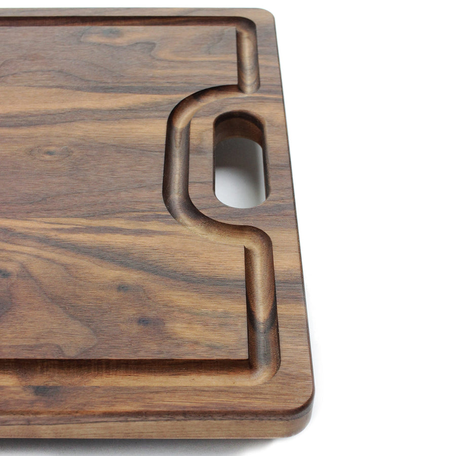 Close view of a walnut board handle and edge channel