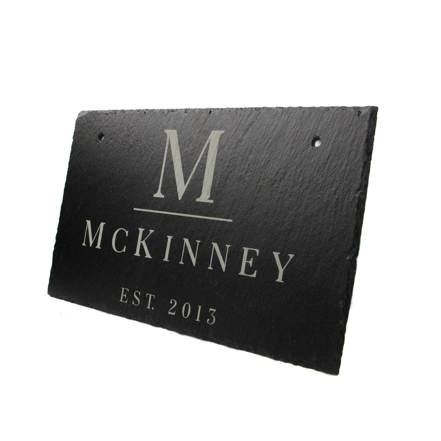Personalized slate name sign photographed from an angle