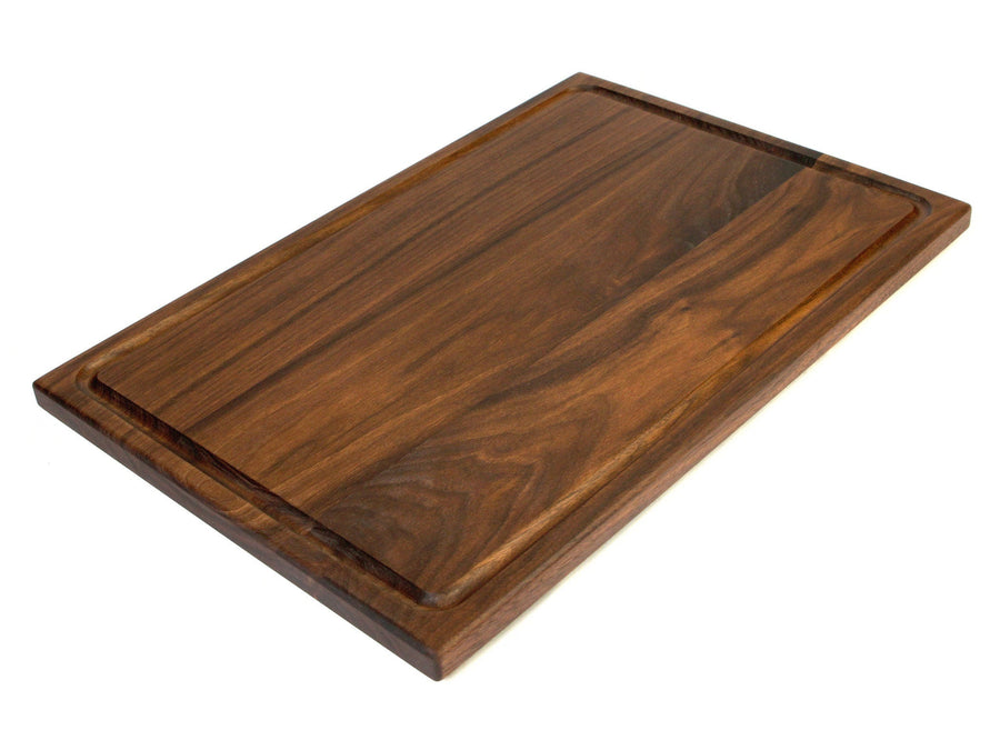 Walnut cutting board with a perimeter juice groove, angled view