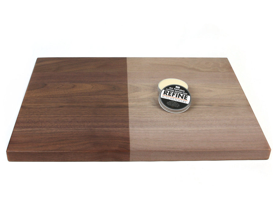 Cutting board wax tin on a wooden board showing contrasting conditioned areas