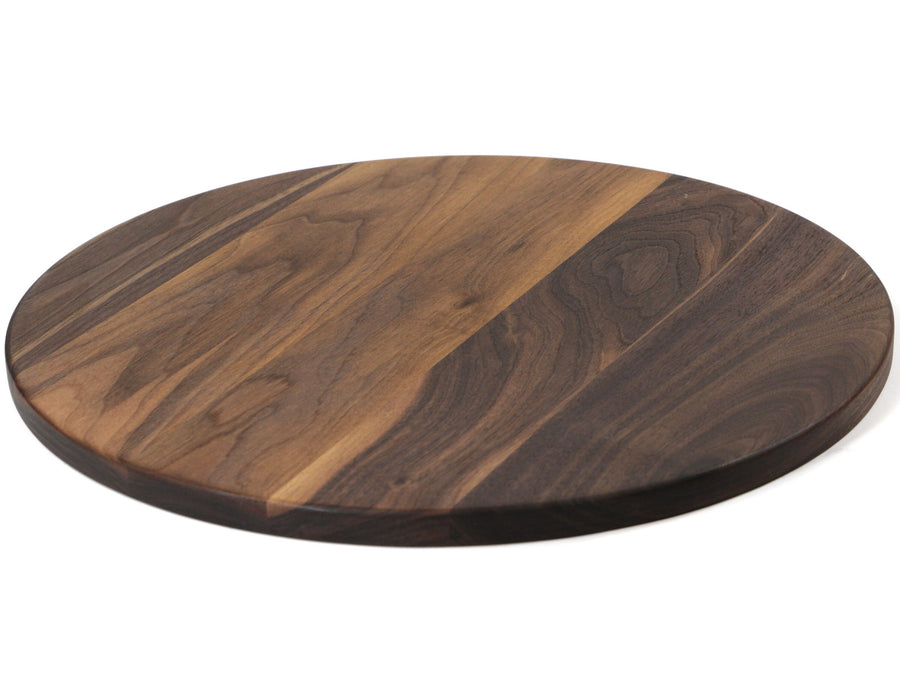 Round walnut cutting board showing the plain reverse surface