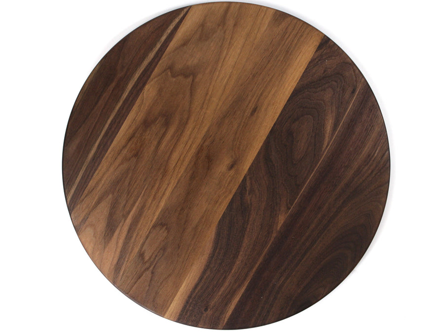 Round walnut board showing a plain reverse surface