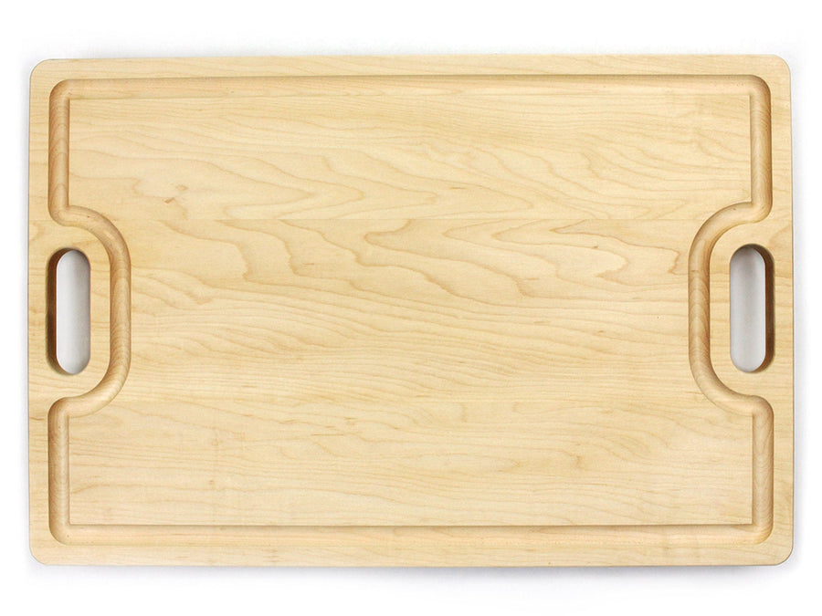 Maple cutting board with two cutout handles, overhead view