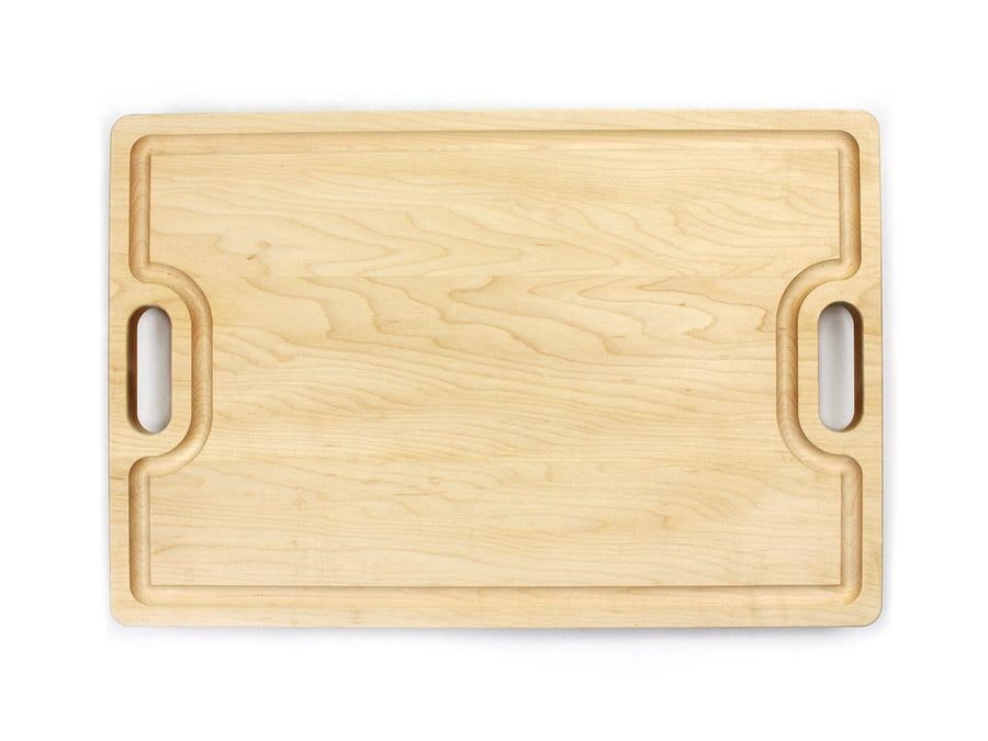 Maple cutting board with two cutout handles and a juice groove
