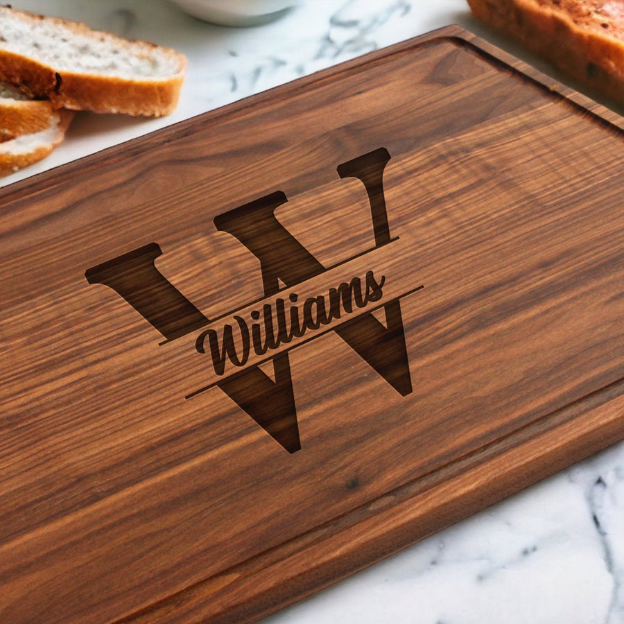 Walnut board engraved with a large initial, surname and established date