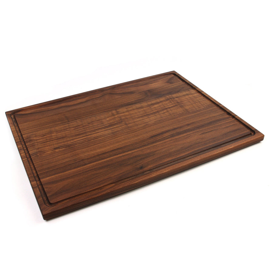 Walnut rectangular cutting board showing a broad surface and edge groove