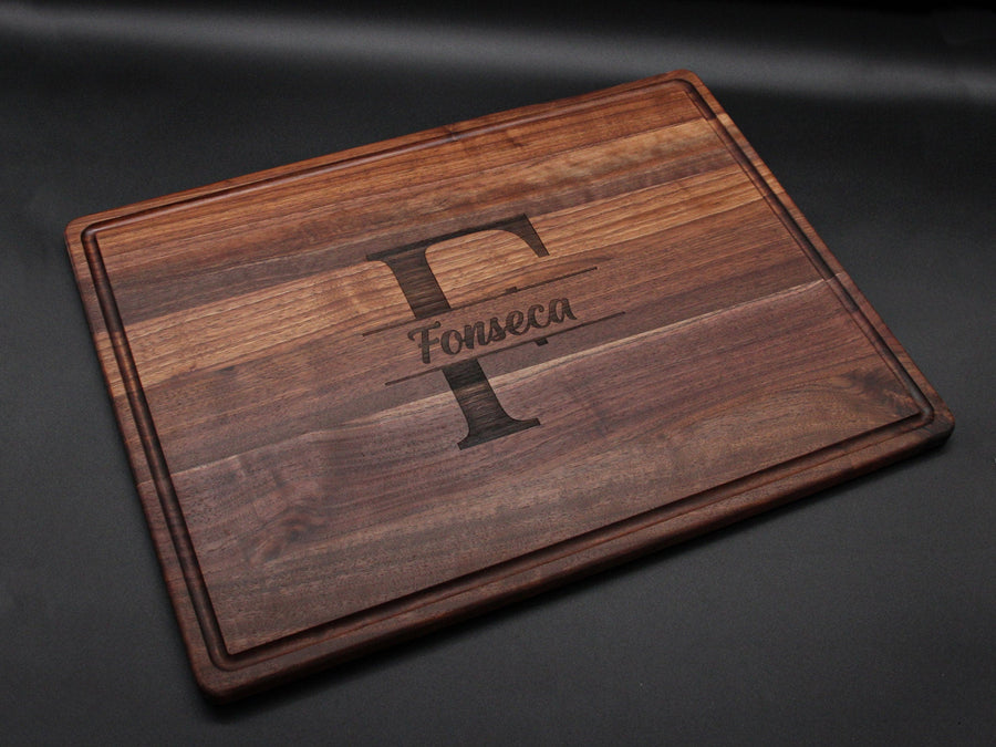 Walnut cutting board with a large initial and surname engraving
