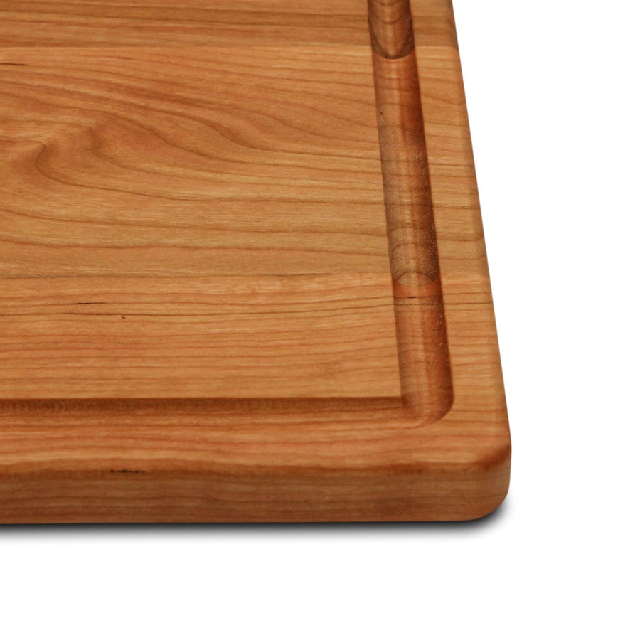 Cherry cutting board corner with a perimeter juice groove