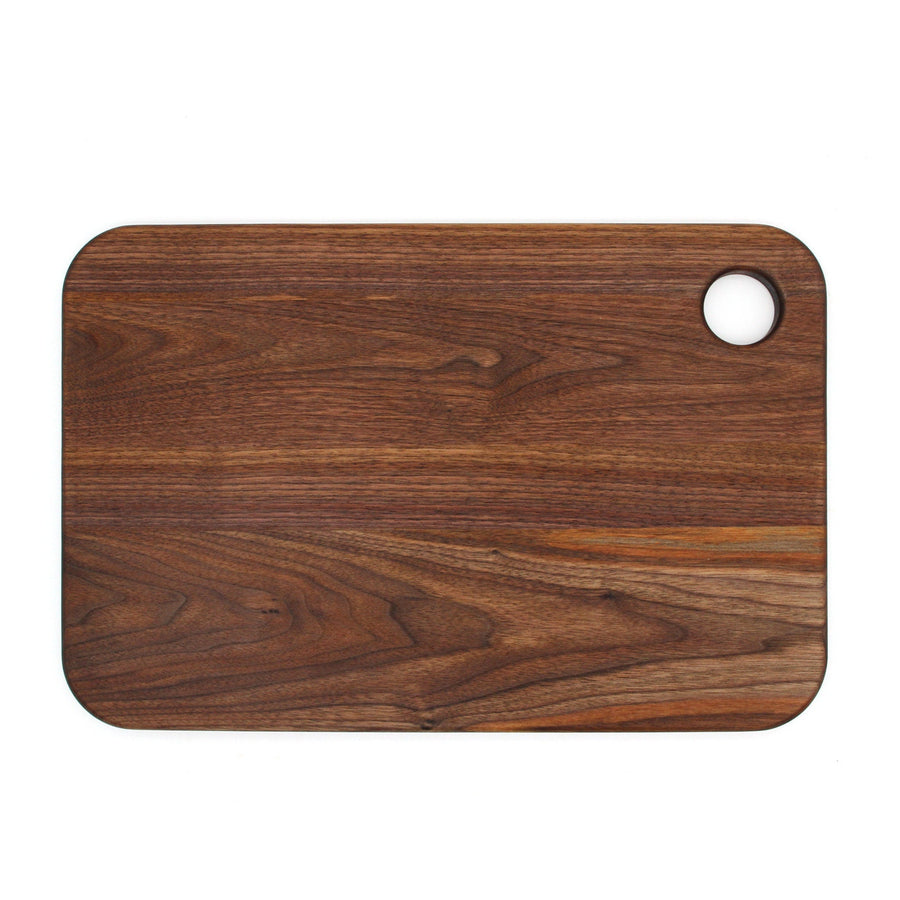 Plain reverse surface of a walnut thumb-hole cutting board