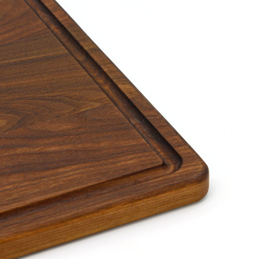 Close view of the edge and juice groove of a walnut board