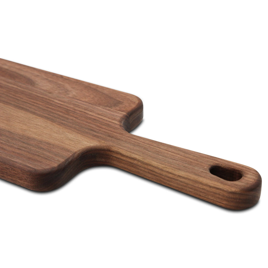 Walnut paddle handle detail showing the transition from board to handle