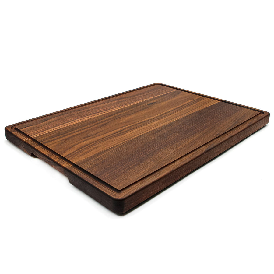 Thick walnut board shown at an angle with its edge profile visible